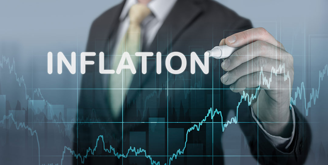 Inflation graph with man writing on it.