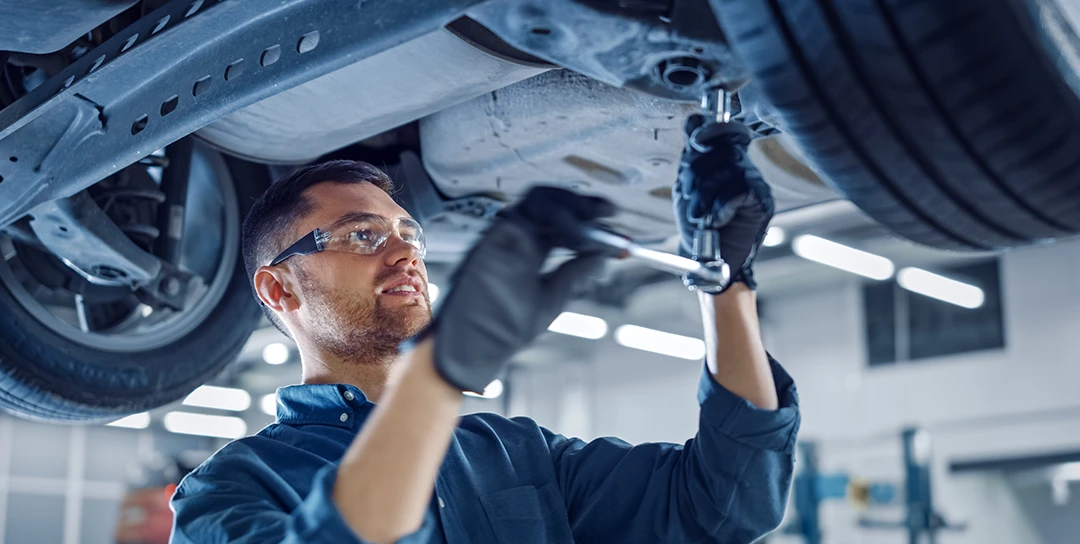 Mechanic working on rear shock.