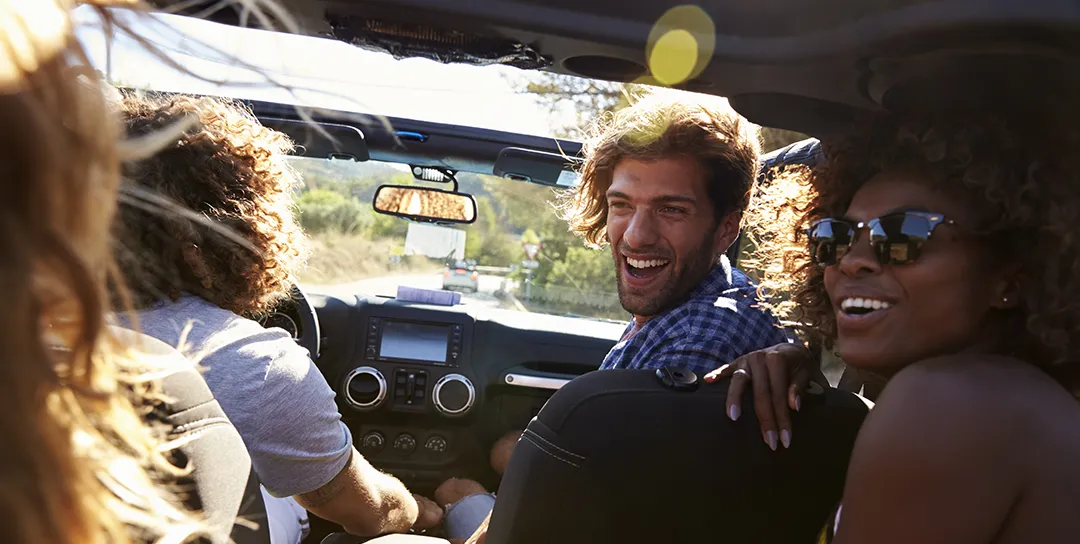 People in car celebrating.