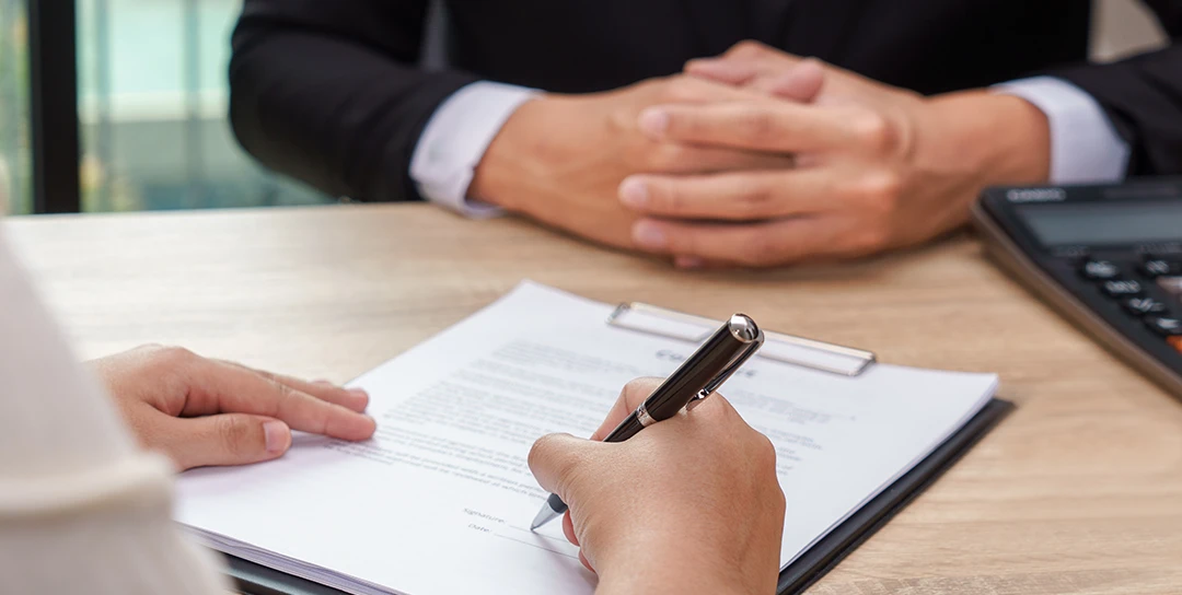 Document signing on a desk.