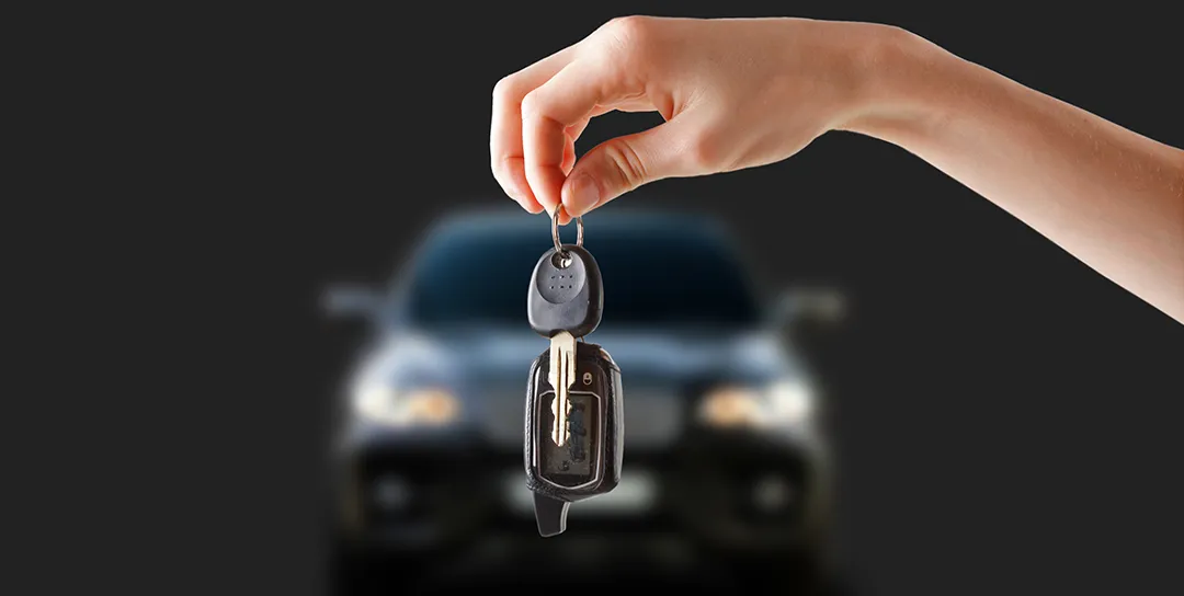 Key dangling in front of car.